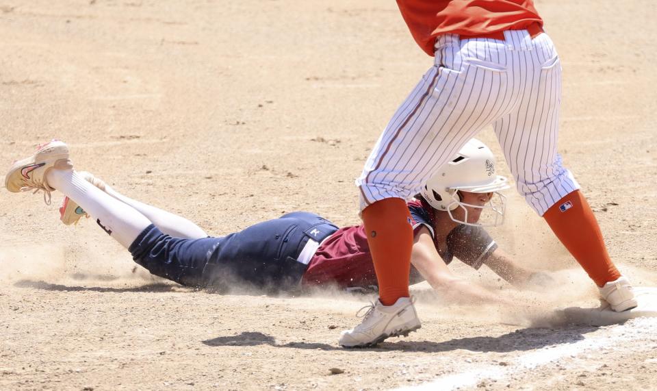 Herriman slides safely back to first base in the 6A semifinal game against Skyridge at the Cottonwood Complex in Murray on Wednesday, May 24, 2023. | Laura Seitz, Deseret News