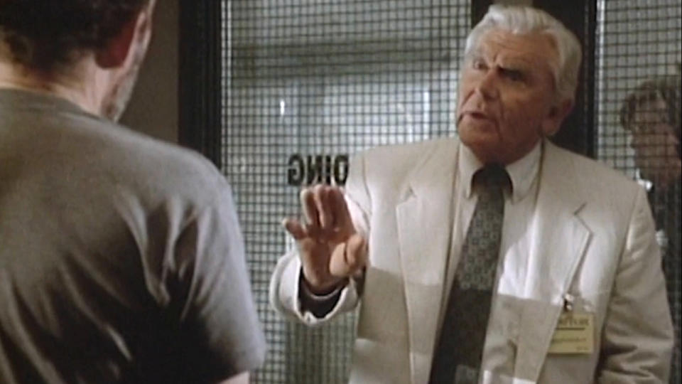 Andy Griffith gestures angrily as he talks with a prisoner in Matlock.