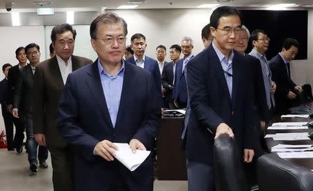 South Korean President Moon Jae-in (L) attends the National Security Council (NSC) meeting in Seoul, South Korea on September 3, 2017. Blue House/Yonhap/via REUTERS