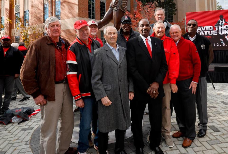 David Thompson poses with members of the 1974 National Championship team after Thompson’s statue was unveiled outside Reynolds Coliseum in Raleigh, N.C., Wednesday, Dec. 6, 2023.