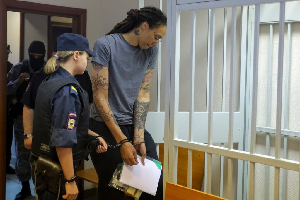 WNBA star and two-time Olympic gold medalist Brittney Griner enters a cage in a courtroom prior to a hearing in Khimki just outside Moscow, Russia, Thursday, Aug. 4, 2022. (Evgenia Novozhenina/Pool Photo via AP)