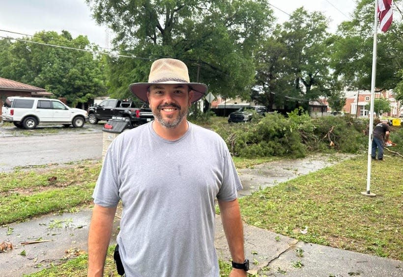 Okaloosa County Commissioner Paul Mixon helps with storm cleanup Friday.