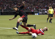 VANCOUVER, CANADA - JANUARY 27: Kelly Parker #15 of Canada makes a sliding tackle to knock the ball away from Monica Ocampo #11 of Mexico during the second half of semifinals action of the 2012 CONCACAF Women's Olympic Qualifying Tournament at BC Place on January 27, 2012 in Vancouver, British Columbia, Canada. (Photo by Rich Lam/Getty Images)