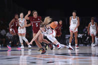 In this photo provided by Bahamas Visual Services, South Carolina forward Victaria Saxton (5) defends against UConn guard Paige Bueckers (5) during an NCAA college basketball game at Paradise Island, Bahamas, Monday, Nov. 22, 2021. (Tim Aylen/Bahamas Visual Services via AP)