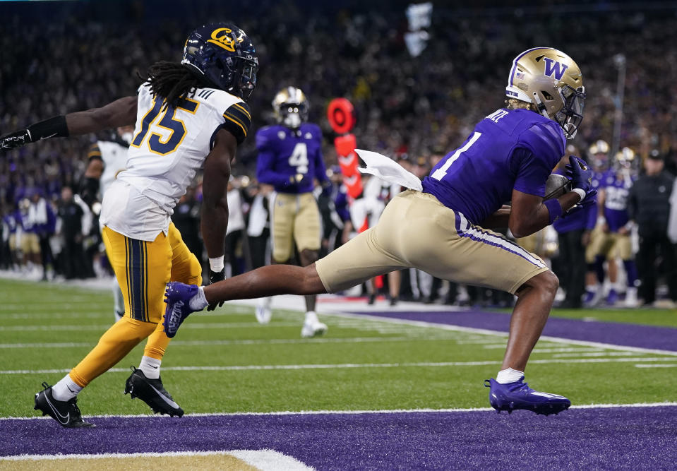 Washington wide receiver Rome Odunze (1) scores a touchdown next to California defensive back Lu-Magia Hearns III (15) during the first half of an NCAA college football game Saturday, Sept. 23, 2023, in Seattle. (AP Photo/Lindsey Wasson)