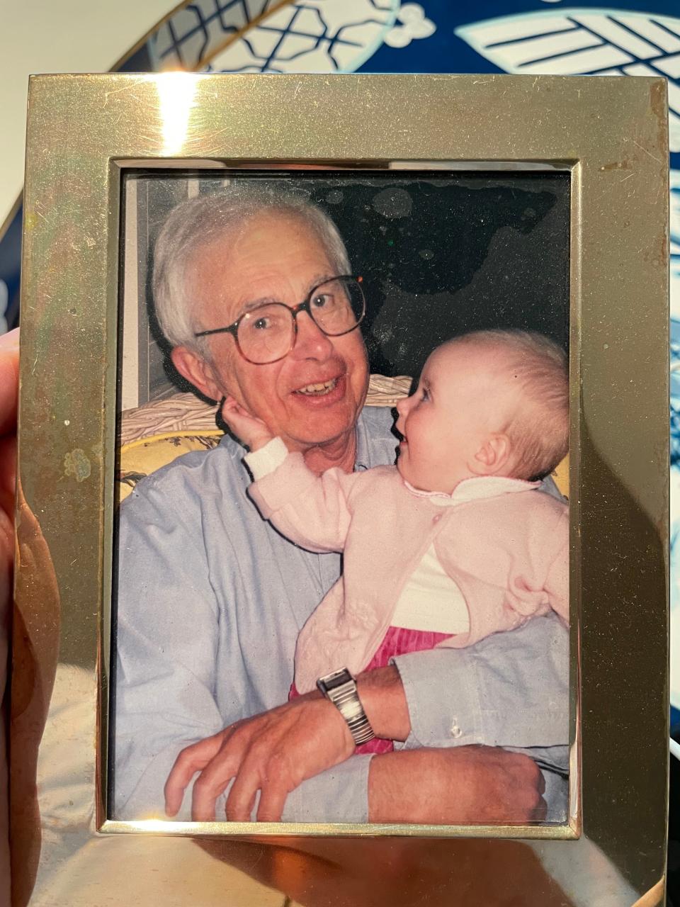 n this undated photo, Carl Sorenson III holds his smiling granddaughter, Isabel, when she was a baby.