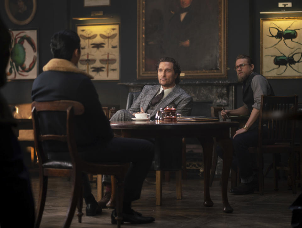 This image released by STXfilms shows, from left, Henry Golding, Matthew McConaughey and Charlie Hunnam in a scene from "The Gentlemen." (Christopher Raphael/STXfilms via AP)