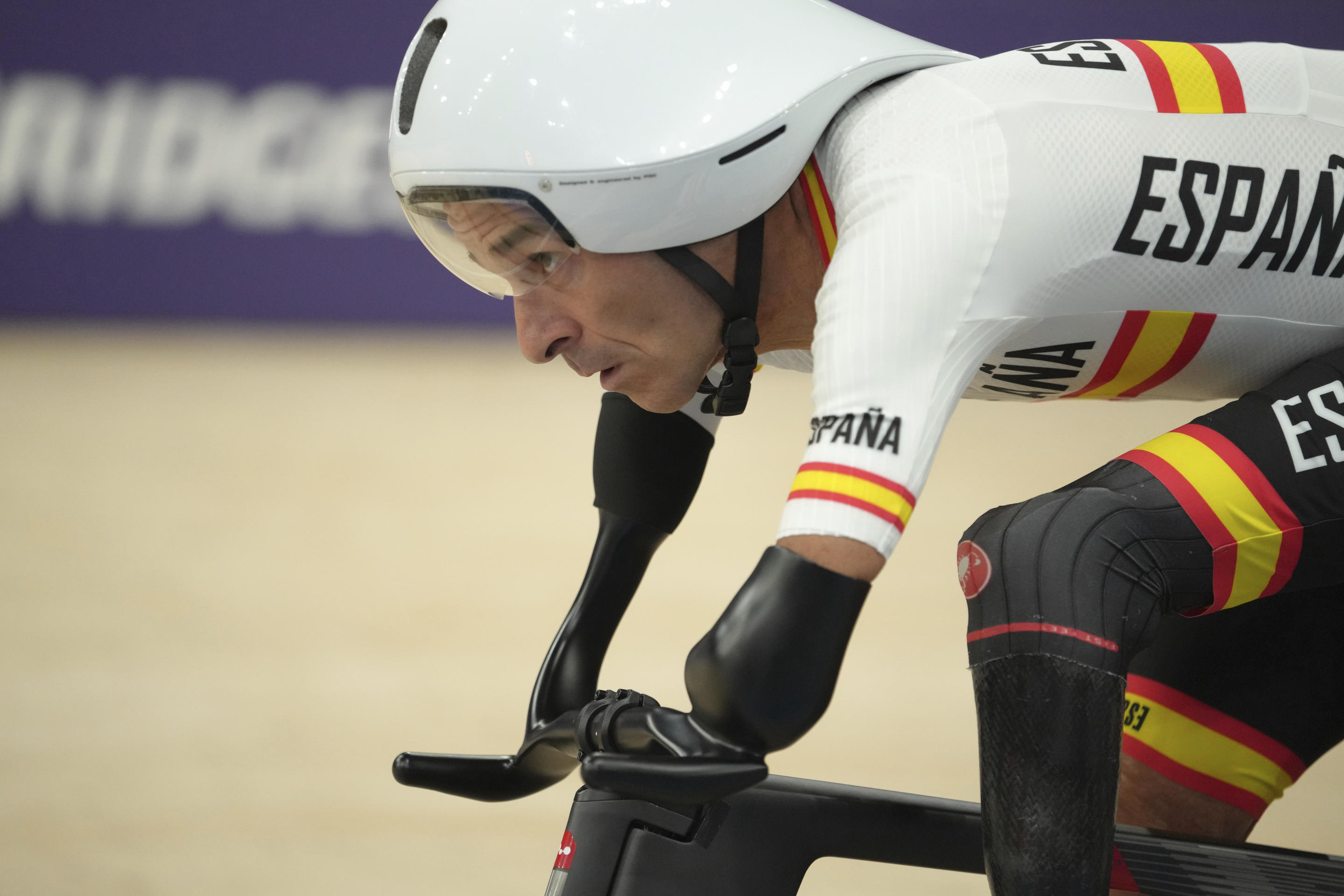 A man races on a bicycle.