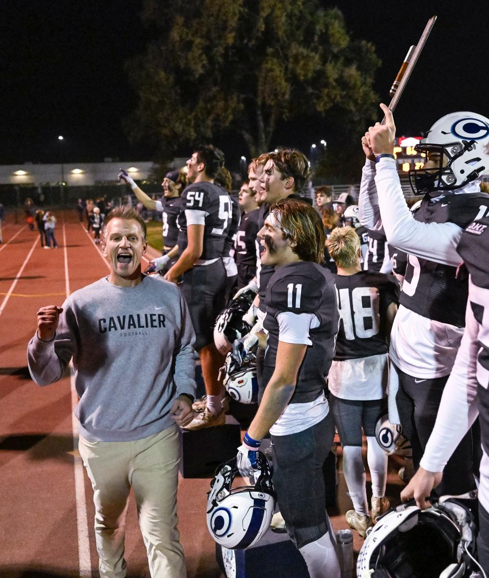 Central Valley Christian Head Coach Mason Hughes celebrates with team after beating Simi Valley in a CIF State Division 2-A Regional Championship Bowl high school football game Saturday, December 2, 2023.