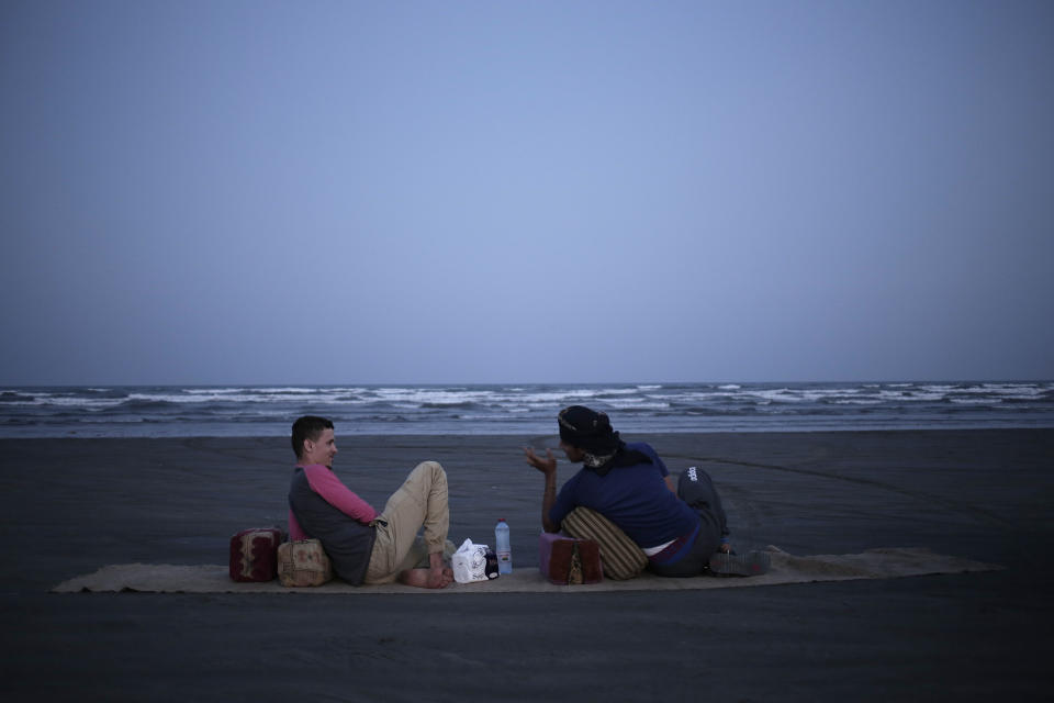 Osama Ahmed, left, and Ahmed Saleh, who both fought during the '2015 battle of Aden' chew Qat by the beach, in Aden, Yemen Feb. 18, 2018. (AP Photo/Nariman El-Mofty)