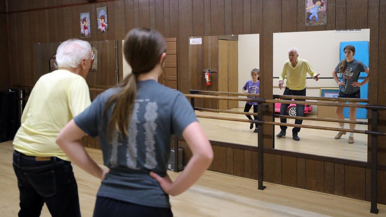 Don McCardle works with Kennedy Henderson, 8, and Miley Genet, 13, during a tap class at McCardle’s Dance Studio in Cuyahoga Falls.