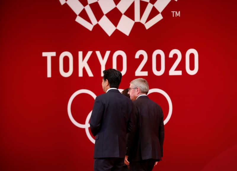 FILE PHOTO : IOC President Bach walks with Japan's PM Abe during the 'One Year to Go' ceremony celebrating one year out from the start of the summer games in Tokyo