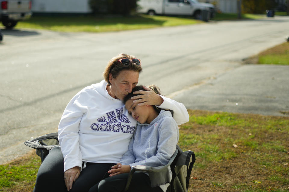 RETRANMISSION TO CORRECT LOCATION - Tammy Asselin, who was at the Just-in-Time Recreation bowling alley with her daughter, Toni, during the recent mass shooting, embrace during an interview in Lewiston, Maine, Friday, Oct. 27, 2023. (AP Photo/Matt Rourke)