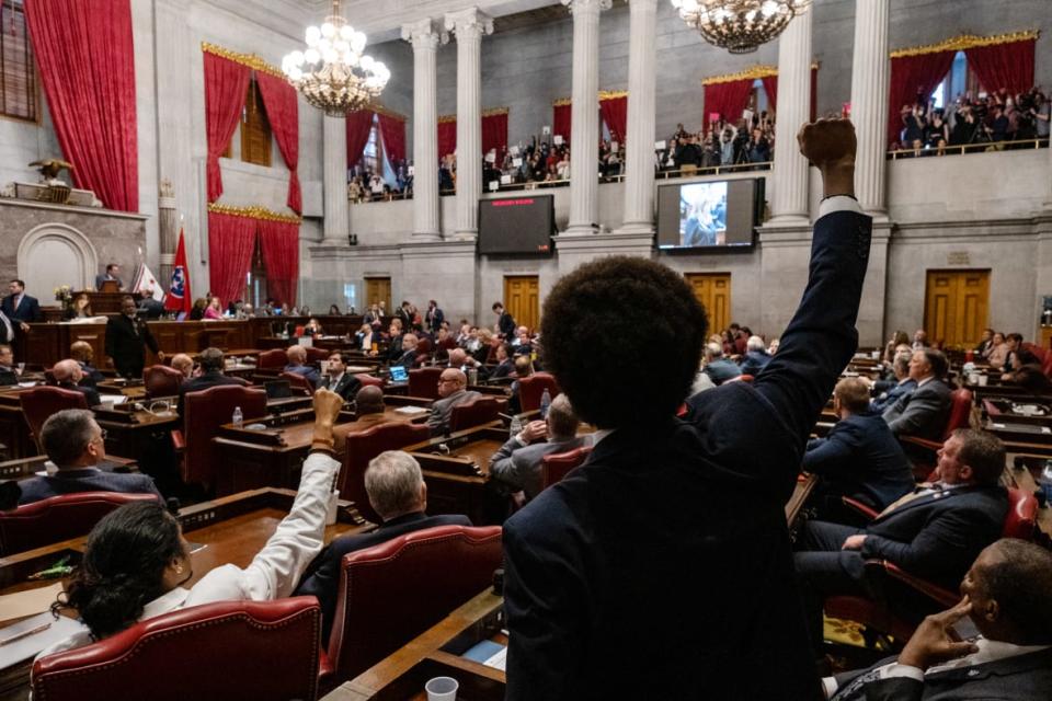 Democratic state Reps. Justin Jones (lower left) of Nashville and Justin Pearson (center) of Memphis gesture to supporters during the vote in which they were expelled from the state Legislature on April 6, 2023, in Nashville, Tennessee. (Photo by Seth Herald/Getty Images)