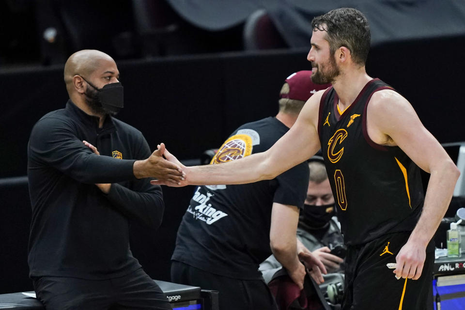 Cleveland Cavaliers' Kevin Love, right, is congratulated by coach J.B. Bickerstaff during the second half of the team's NBA basketball game against the Boston Celtics, Wednesday, May 12, 2021, in Cleveland. The Cavaliers won 102-94. (AP Photo/Tony Dejak)