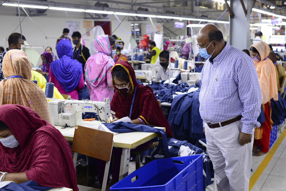 Shafiqul Islam watches employees work at Arrival Fashion Ltd., a new-generation garment factory spread over 2.5 acres and surrounded by lush paddy fields in Gazipur, on the outskirts of capital Dhaka, Bangladesh, Saturday, March 13, 2021. Islam was studying business at Dhaka College in 1971 when a bloody and brutal war for independence ravaged Bangladesh. After undergoing guerrilla training in India, he returned to fight against Pakistani soldiers. “It was a time of total destruction,” he said. “Our bridges and roads were destroyed, our women were raped, towns were under siege. Thousands of homes and shops were torched.” (AP Photo/Mahmud Hossain Opu)