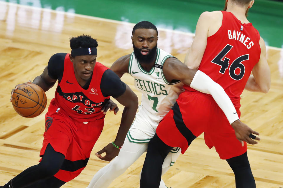 Boston Celtics' Jaylen Brown (7) defends against Toronto Raptors' Pascal Siakam (43) as Aron Baynes (46) provides a screen during the first half of an NBA basketball game, Thursday, Feb. 11, 2021, in Boston. (AP Photo/Michael Dwyer)