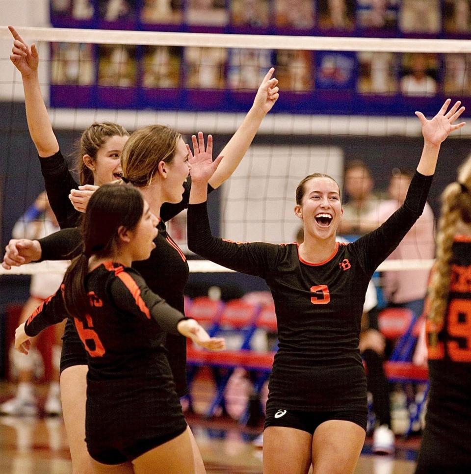 Dani Sparks (3) and teammates Amika Swanson, Haylee LaFontaine and Estela Escura celebrate their victory at Los Alamitos.