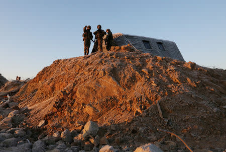 South Korean army soldiers stand guard at the dismantled guard post inside the Demilitarized Zone (DMZ) in the central section of the inter-Korean border in Cheorwon, Korea, December 12, 2018. Ahn Young-joon/Pool via REUTERS