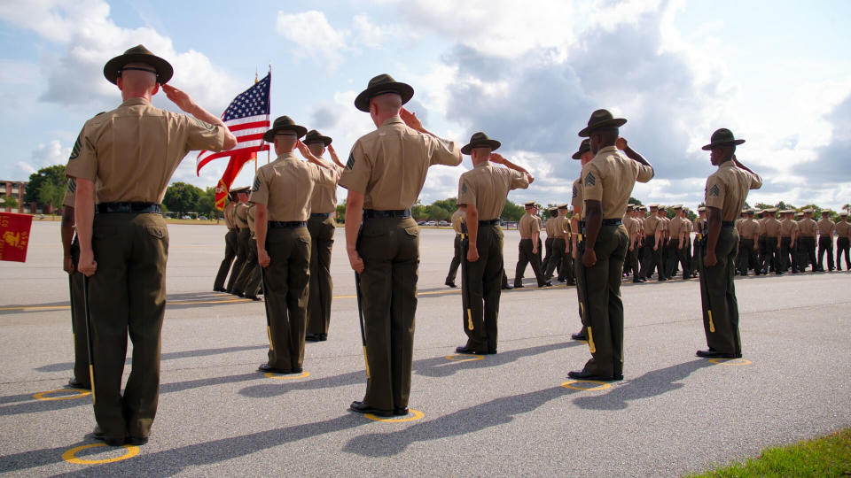 Dramatic shot of Drill Instructors saluting the U.