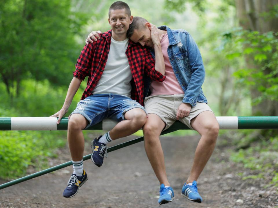 Gay married couple Dawid Mycek (35) and Jakub Kwiecinski (38), who were featured in an advert for Durex condoms along with straight couples, embrace as they pose for a photograph in Hel, Poland June 11, 2020. Picture taken June 11, 2020. REUTERS/Matej Leskovsek