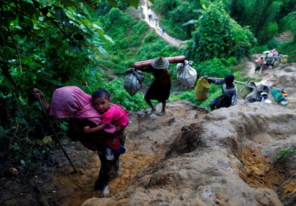 Rohingya refugees climb up a hill after crossing the Bangladesh-Myanmar border in Cox's Bazar, Bangladesh, on Sept. 8, 2017.