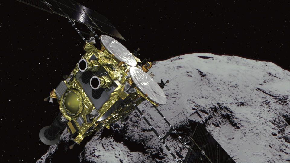 FILE - This computer graphics image provided by the Japan Aerospace Exploration Agency (JAXA) shows an asteroid and asteroid explorer Hayabusa2. The Japanese unmanned spacecraft Hayabusa2 released two small Minerva-II-1 rovers on the asteroid Ryugu on Friday, Sept. 21, 2018, in a research effort that may provide clues to the origin of the solar system. JAXA said confirmation of the rovers' touchdown has to wait until it receives data from them on Saturday. (JAXA via AP)