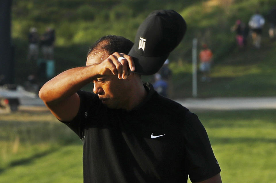 Tiger Woods removes his hat after finishing the second round of the PGA Championship golf tournament, Friday, May 17, 2019, at Bethpage Black in Farmingdale, N.Y. (AP Photo/Andres Kudacki)