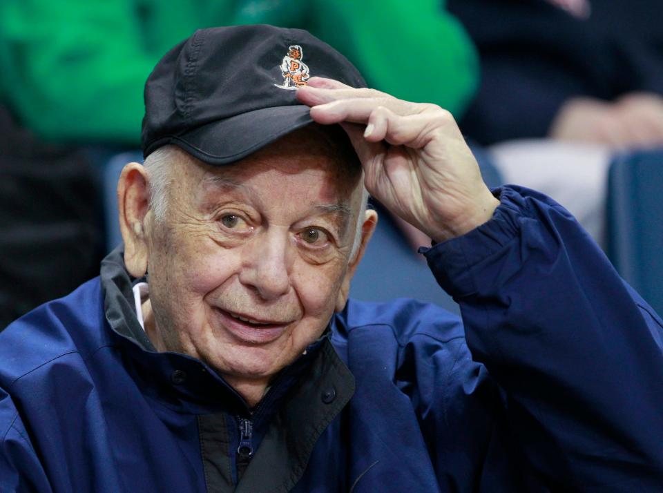 Former Princeton basketball coach Pete Carril tips his hat during an NCAA college basketball game between Richmond and La Salle on Feb. 5, 2015, in Philadelphia. Carril, the rumpled, cigar-smoking coach who led Princeton to 11 appearances in the NCAA tournament, where his teams unnerved formidable opponents and rattled March Madness with old-school fundamentals, died Monday, Aug. 15, 2022. He was 92. 