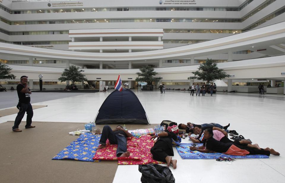 Anti-government protesters rest during a rally at a government complex in Bangkok