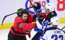 Ottawa Senators' Jack Kopacka (59) battles with Winnipeg Jets' Logan Stanley (64) during the second period of an NHL hockey game Wednesday, April 14, 2021, in Ottawa, Ontario. (Sean Kilpatrick/The Canadian Press via AP)