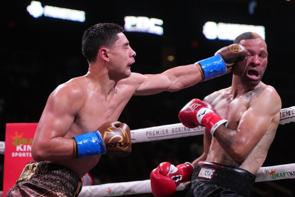 Elijah Garcia (brown trunks) and Rowdy Montgomery (black trunks) box during their middleweight boxing match during a Premier Boxing Champions card at Gila River Arena.