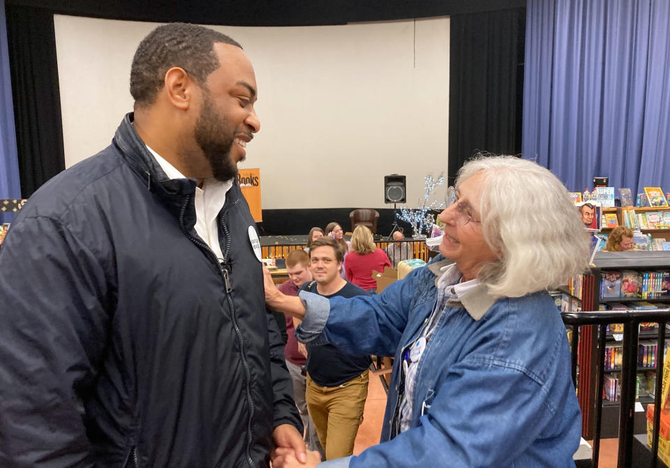 Democratic U.S. Senate candidate Charles Booker chats with a supporter at a rally in Morehead, Ky., on Tuesday, Nov. 1, 2022. Booker is stressing his support for abortion rights in challenging Republican Sen. Rand Paul. (AP Photo/Bruce Schreiner)