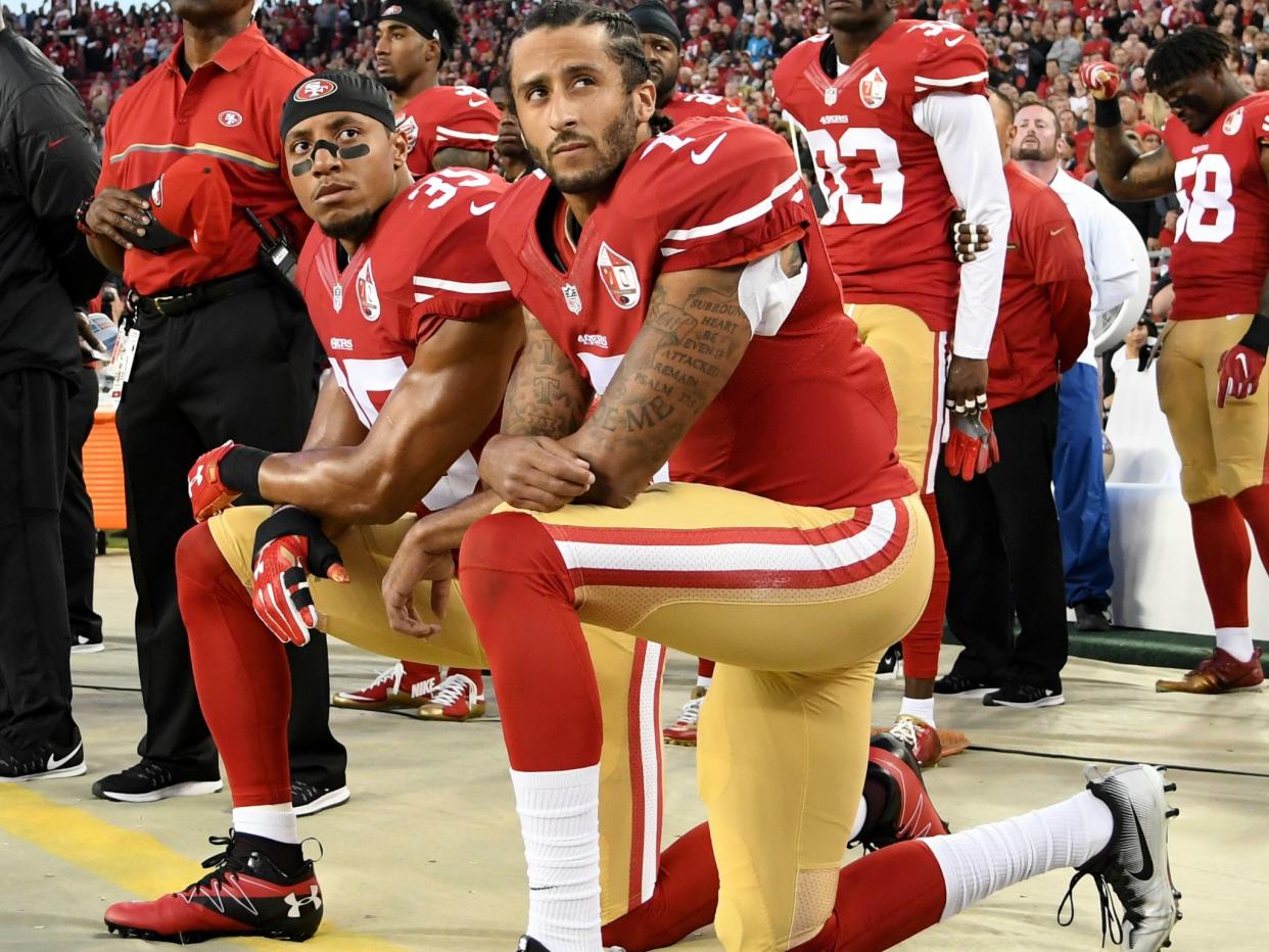 Colin Kaepernick (right) and Eric Reid of the San Francisco 49ers kneel in protest during the national anthem prior to an NFL game in Santa Clara, California: Getty