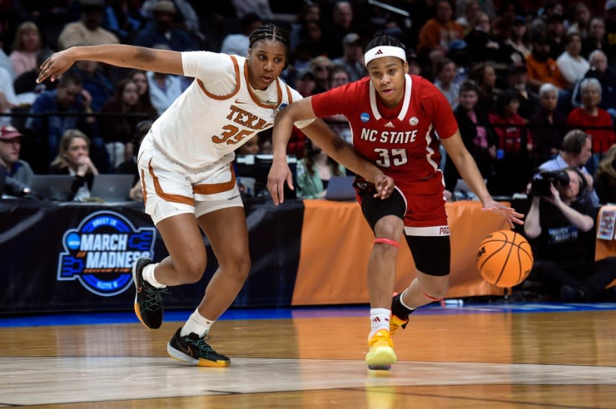 North Carolina State guard Zoe Brooks (35) tries to get around Texas forward Madison Booker (35) during the first half of an Elite Eight college basketball game in the women’s NCAA Tournament, Sunday, March 31, 2024, in Portland, Ore. (AP Photo/Steve Dykes)