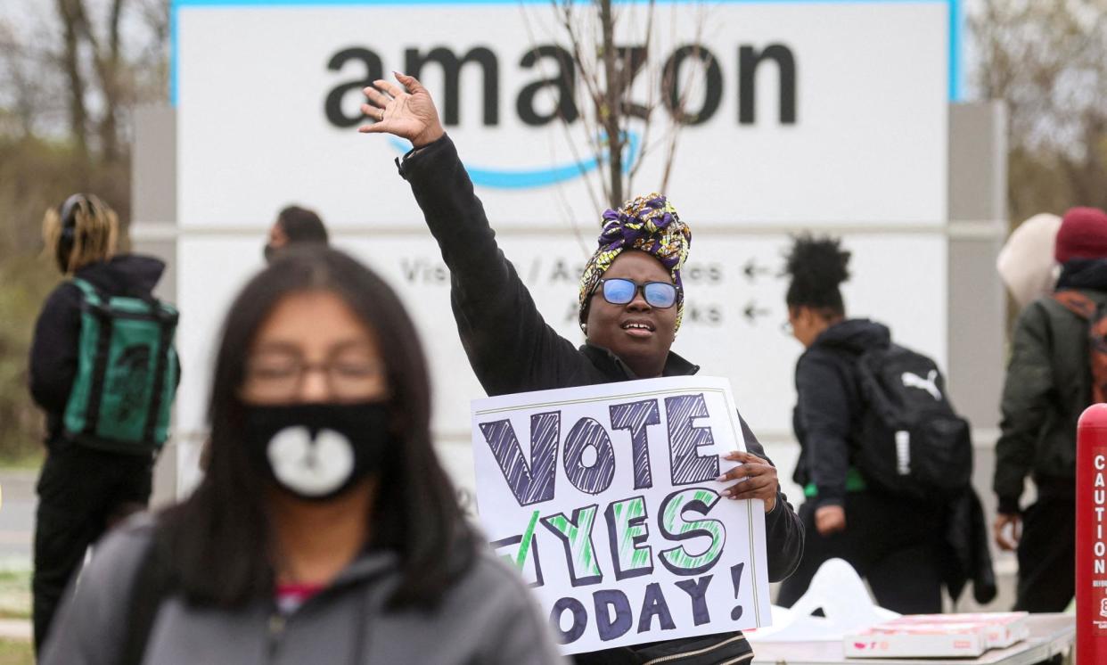 <span>An Amazon Labor Union organizer greets workers as employees begin voting to unionize a warehouse in New York City on 25 April 2022. </span><span>Photograph: Brendan McDermid/Reuters</span>