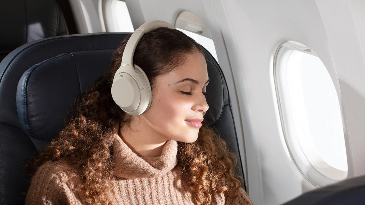  Sony WH-1000XM4 worn by a woman on an airplane. 