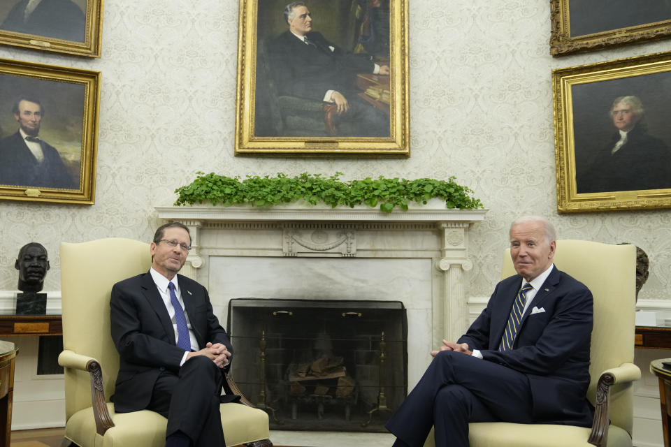 President Joe Biden and Israel's President Isaac Herzog listen to reporters' questions as they meet in the Oval Office of the White House in Washington, Tuesday, July 18, 2023. (AP Photo/Susan Walsh)