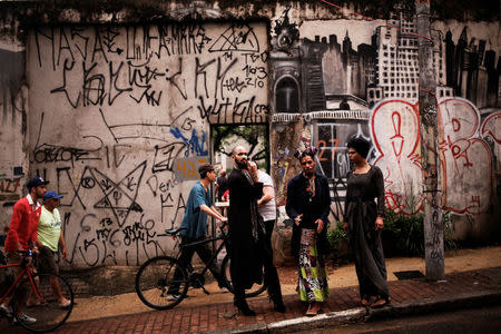 Fernanda, 20, Rodrigo, 26, and Teflon, 19, who are among members of lesbian, gay, bisexual and transgender (LGBT) community, that have been invited to live in a building that the roofless movement has occupied, stand at an entrance of the building, in downtown Sao Paulo, Brazil, November 6, 2016. REUTERS/Nacho Doce