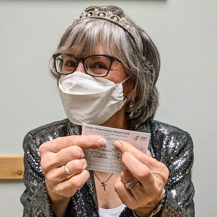 Terez Giuliana receives her first Covid-19 injection in January 2021, dressed in a tiara and sparkly jacket for the occasion. (Terez Giuliana)