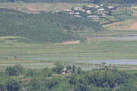 North Korea's town Kaepoong behind a military guard post, bottom, is seen from the unification observatory in Paju, South Korea, Tuesday, May 28, 2024. A rocket launched by North Korea to deploy the country's second spy satellite exploded shortly after liftoff Monday, state media reported, in a setback for leader Kim Jong Un's hopes to operate multiple satellites to better monitor the U.S. and South Korea. (AP Photo/Lee Jin-man)