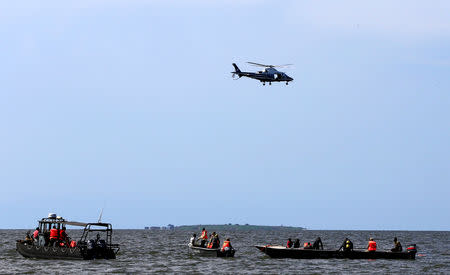 Rescue and recovery missions search for the bodies of dead passengers after a cruise boat capsized in Lake Victoria off Mukono district, Uganda November 25, 2018. REUTERS/James Akena