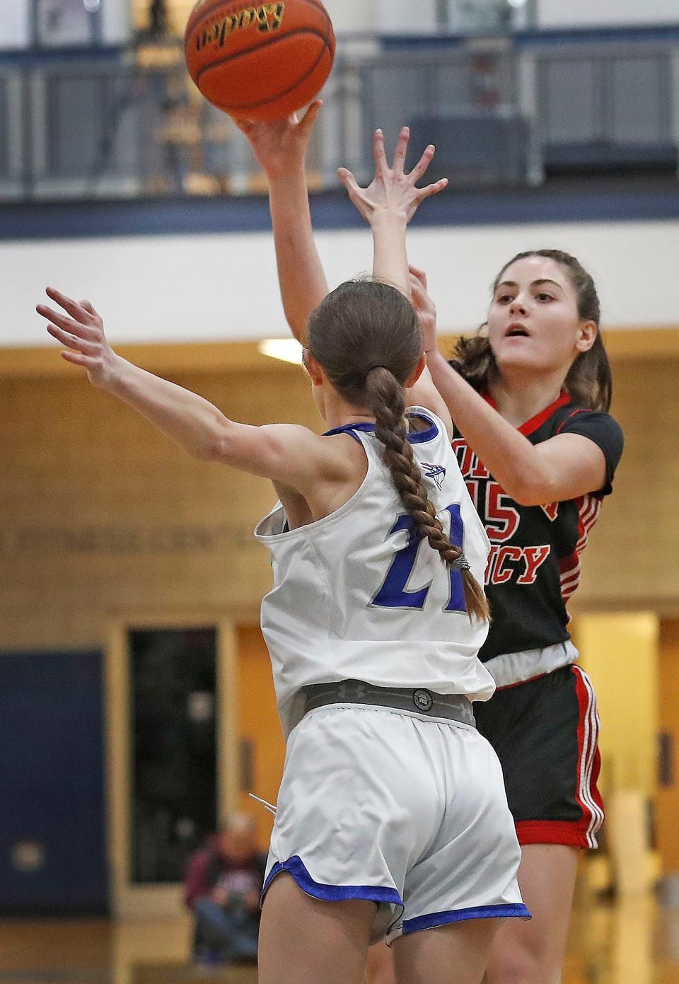 Quincy guard Caroline Campbell tries to block a North shot by Ava Bryan.
Quincy High hosted North Quincy High in basketball. Both girls and boys teams played on Friday January 20, 2023.