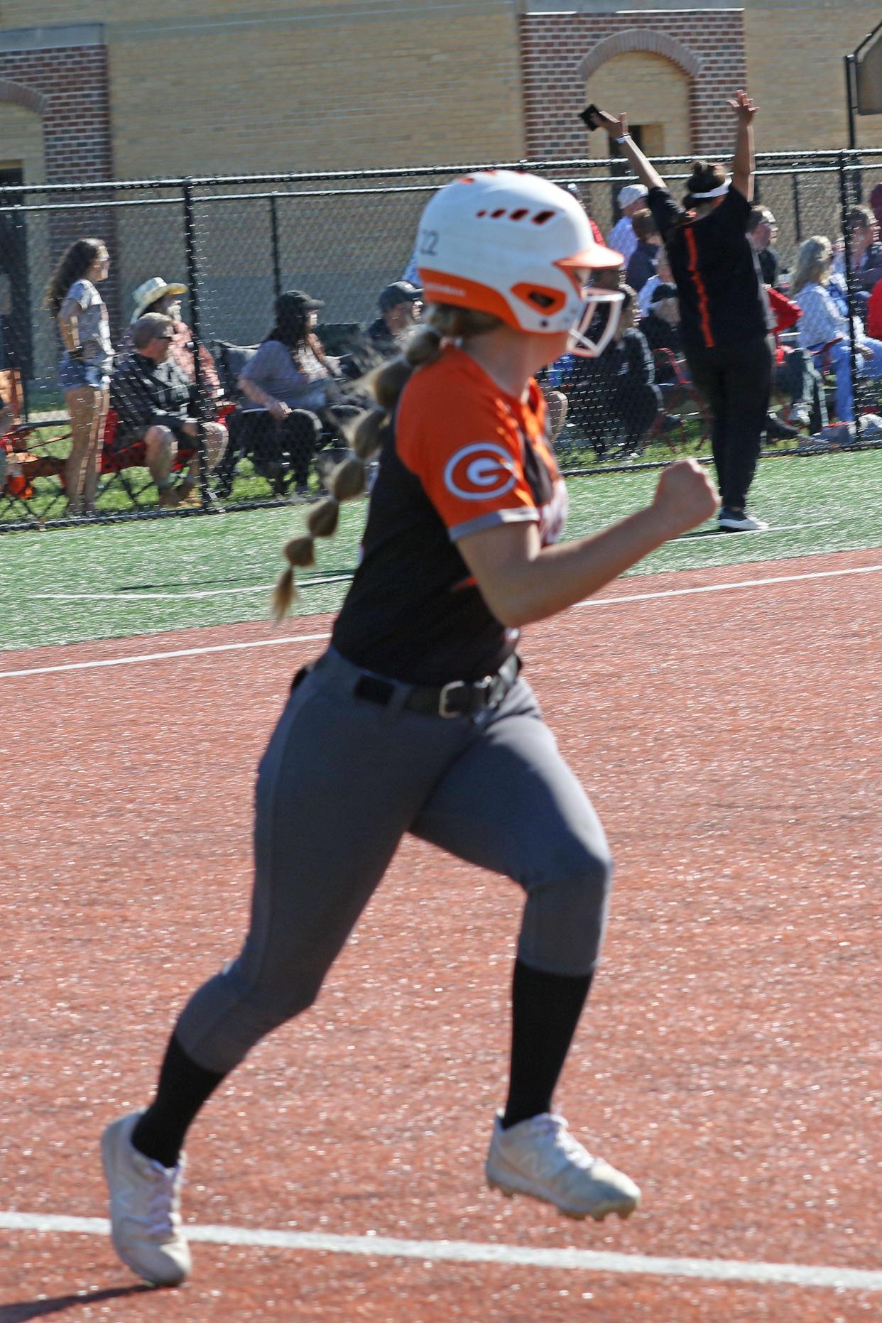 Gibsonburg's Mariah McNett and coach Sarah Gruner watch as the ball clears the fence.