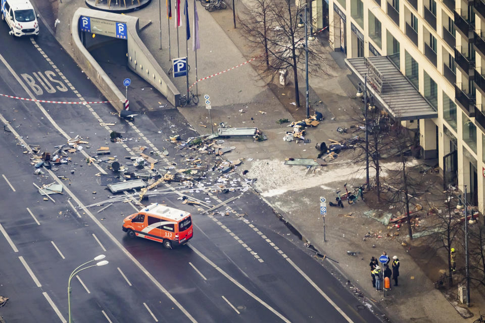 Debris lay in front of a hotel in Berlin, Germany, Friday, Dec. 16, 2022. German police say a huge fish tank in the center of Berlin has burst, causing a wave of devastation in and around the Sea Life tourist attraction. (Christoph Soeder/dpa via AP)