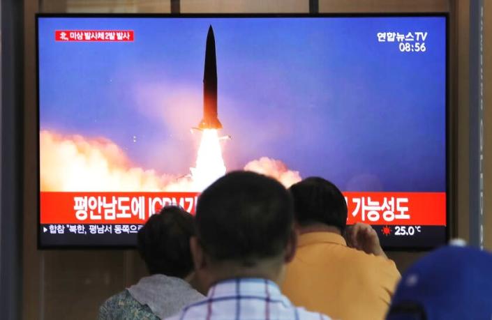 People watch a TV showing a file image of a North Korea's missile launch during a news program at the Seoul Railway Station in Seoul, South Korea, Tuesday, Sept. 10, 2019. North Korea launched at least two unidentified projectiles toward the sea on Tuesday, South Korea's military said, hours after the North offered to resume nuclear diplomacy with the United States but warned its dealings with Washington may end without new U.S. proposals. The sign reads &quot;North Korea launched at least two unidentified projectiles.&quot; (AP Photo/Ahn Young-joon)