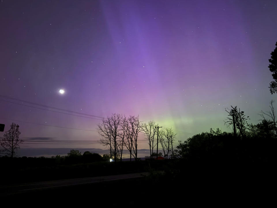 The Aurora Borealis, also known as the Northern Lights, is visible over Ann Arbor, Mich., early Saturday, May, 11, 2024. Brilliant purple, green, yellow and pink hues of the Northern Lights were reported worldwide, with sightings in Germany, Switzerland, London, and the United States and Canada. (AP Photo/Dee-Ann Durbin)