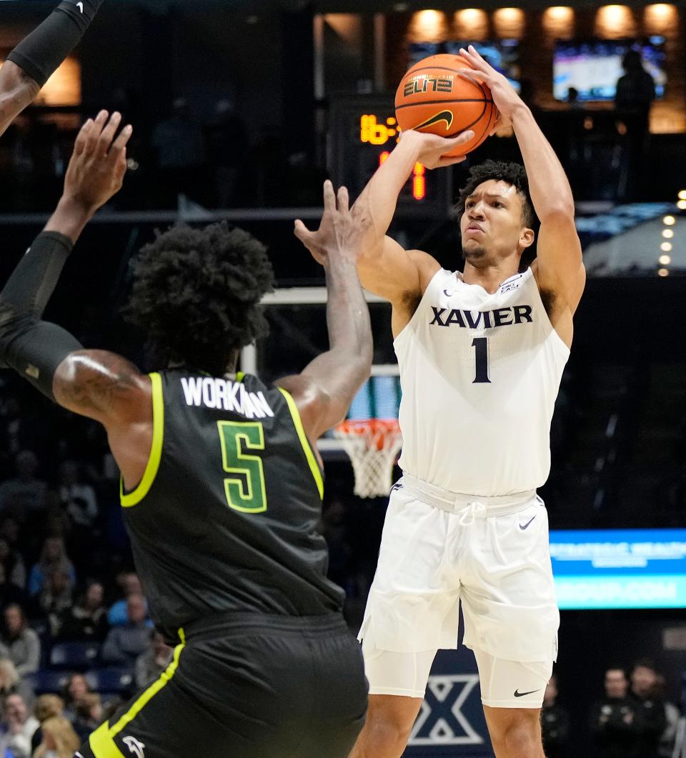 Xavier Musketeers guard Desmond Claude (1) takes a shot over Jacksonville Dolphins forward Bryce Workman (5) in the first half at the Cintas Center Friday, November 10, 2023.