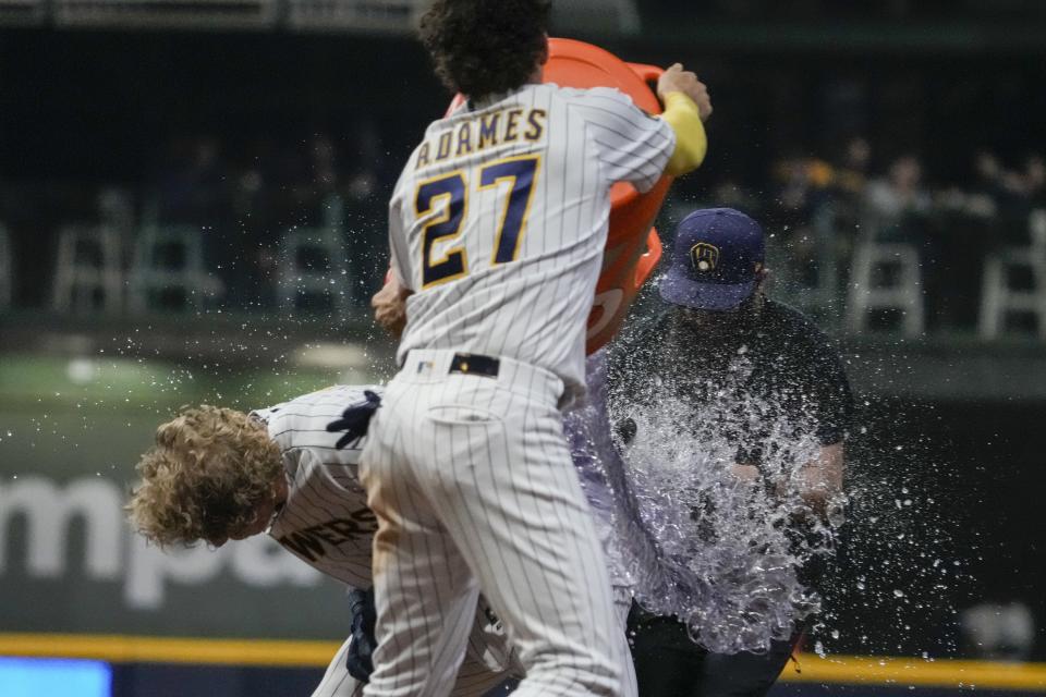 Milwaukee Brewers' Joey Wiemer is dunked by Willy Adames after hitting a walk off RBI sacrifice fly during the ninth inning of a baseball game against the Kansas City Royals Saturday, May 13, 2023, in Milwaukee. The Brewers won 4-3. (AP Photo/Morry Gash)