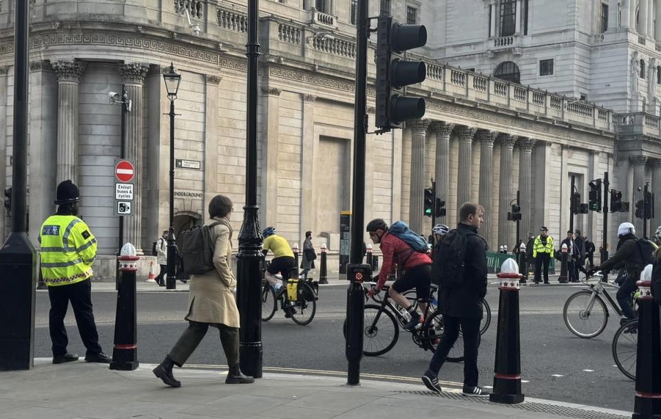 Police officers wait at traffic light to observe cyclists (City of London Police)